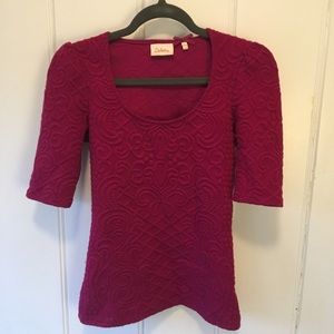 Fitted magenta sweater with 3/4 sleeves.
